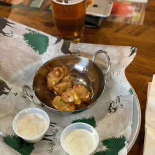 a plate of food and a glass of beer