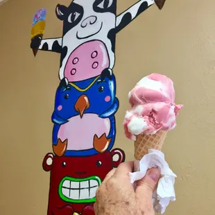 a hand holding an ice cream cone