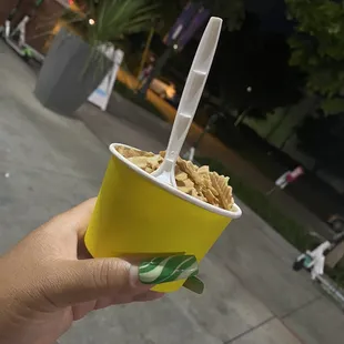 Chocolate ice cream topped with caramel and waffle pieces