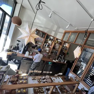 people in a bakery looking at pastries