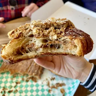 Inside of twice-baked pecan + oat croissant-- filled and topped with to-die-for filling that makes it almost like biting into a pecan pie