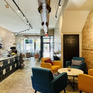 a coffee shop with a brick wall