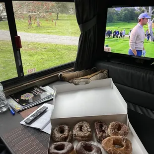 a box of doughnuts in front of a television