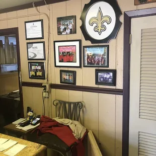 a wall with pictures and a clock