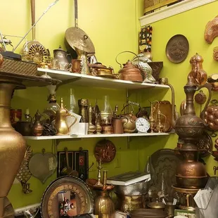 a collection of copper pots and pans