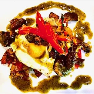 Over easy eggs, peppers, potatoes, cilantro pepper sauce