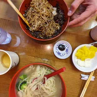 a bowl of noodles and chopsticks