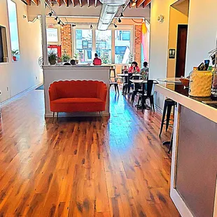 a coffee shop with a red couch