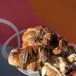 a person holding a plate of pastries
