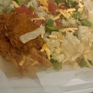 "buffalo shrimp salad." Super breaded shrimp, iceberg lettuce, processed shredded cheese, and a tasteless pepper and tomato for color.