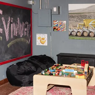 a living room with a chalkboard on the wall