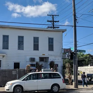 a white van parked in front of a white building