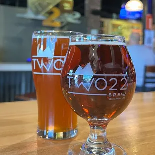 two glasses of beer on a table