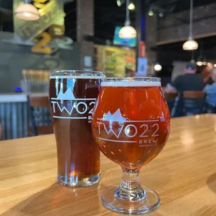 two glasses of beer on a table