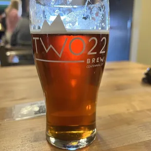 a pint of beer on a table