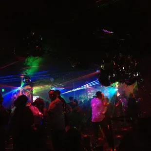 a group of people dancing in a club