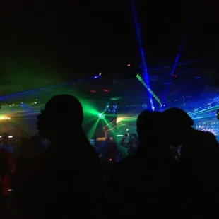 silhouettes of people dancing at a party