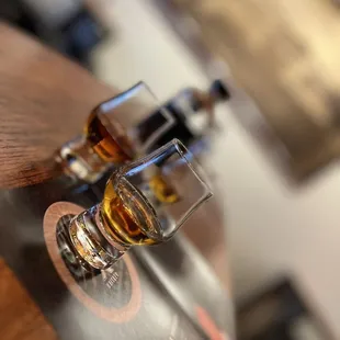 two glasses of whiskey on a table