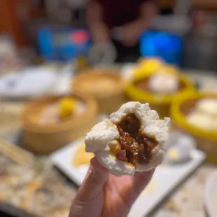 a hand holding a piece of food