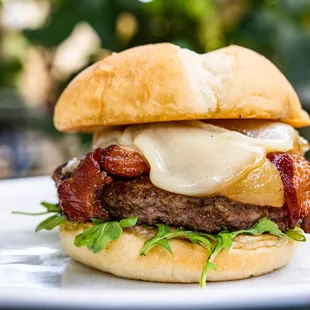 a hamburger with bacon and cheese