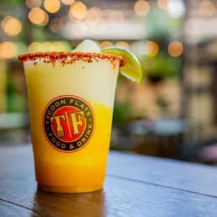 a drink with a lime garnish