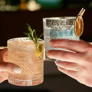 two people toasting with drinks