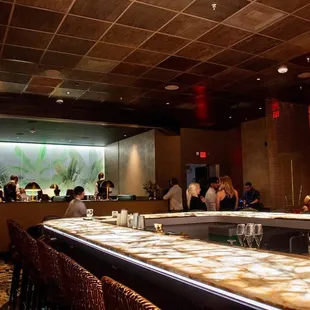 a bar with people sitting at it