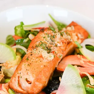 a plate of salmon and vegetables