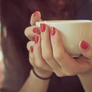 a woman holding a coffee cup