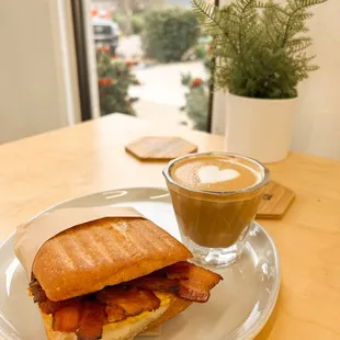 a breakfast sandwich and a cup of coffee