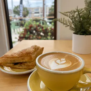 a cup of cappuccino and a sandwich