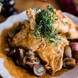 Pan Fried Airline Chicken with Roasted Grapes and Pinot Noir Pan Sauce Photo Credit: The Malicotes