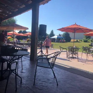 a patio with tables and umbrellas