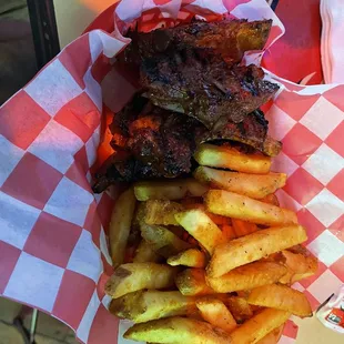 Ribs and seasoned fries.