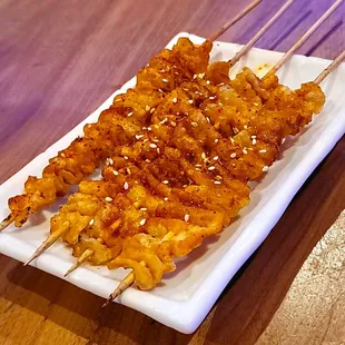 chicken skewers on a white plate