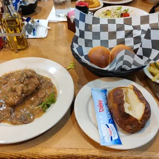 Chopped sirloin with mushro gravy, mixed greens, a baked potato, salad, a roll, and cream of of broccoli soup. All for $12.