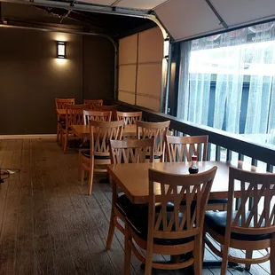 a view of a dining room with wooden tables and chairs