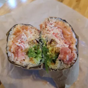 Salmon, tuna, shrimp tempura, fried crawfish, rice, onion, seaweed salad, cucumber, and avocado