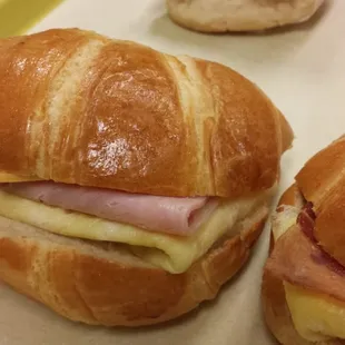  a croissant sandwich with ham and cheese