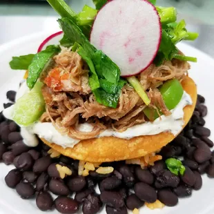 Pulled Pork Tostada with fresh watercress salad.