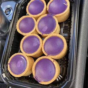 a tray of purple desserts