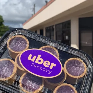 a person holding a box of pies