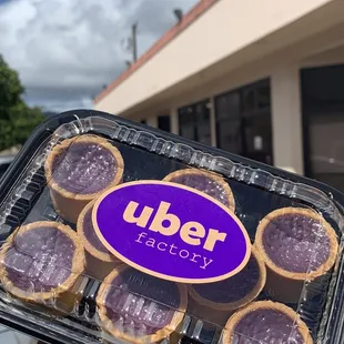a person holding a tray of cookies