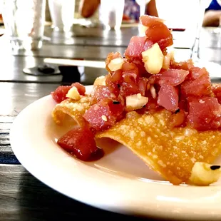 Tuna and macadamia nut nuts on a fried wonton.