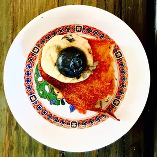 Fish liver with pickled blueberry and honey.