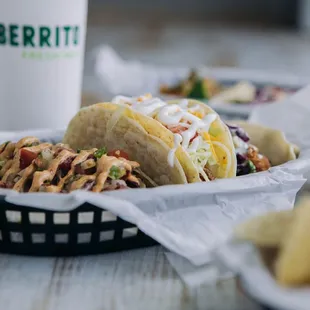 a plate of tacos and chips on a table