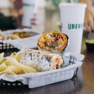 a burrito with chips and a drink