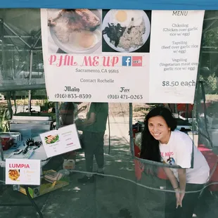 a woman standing under a tent