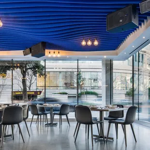 a dining room with a blue ceiling