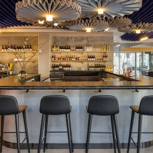 a bar with black stools